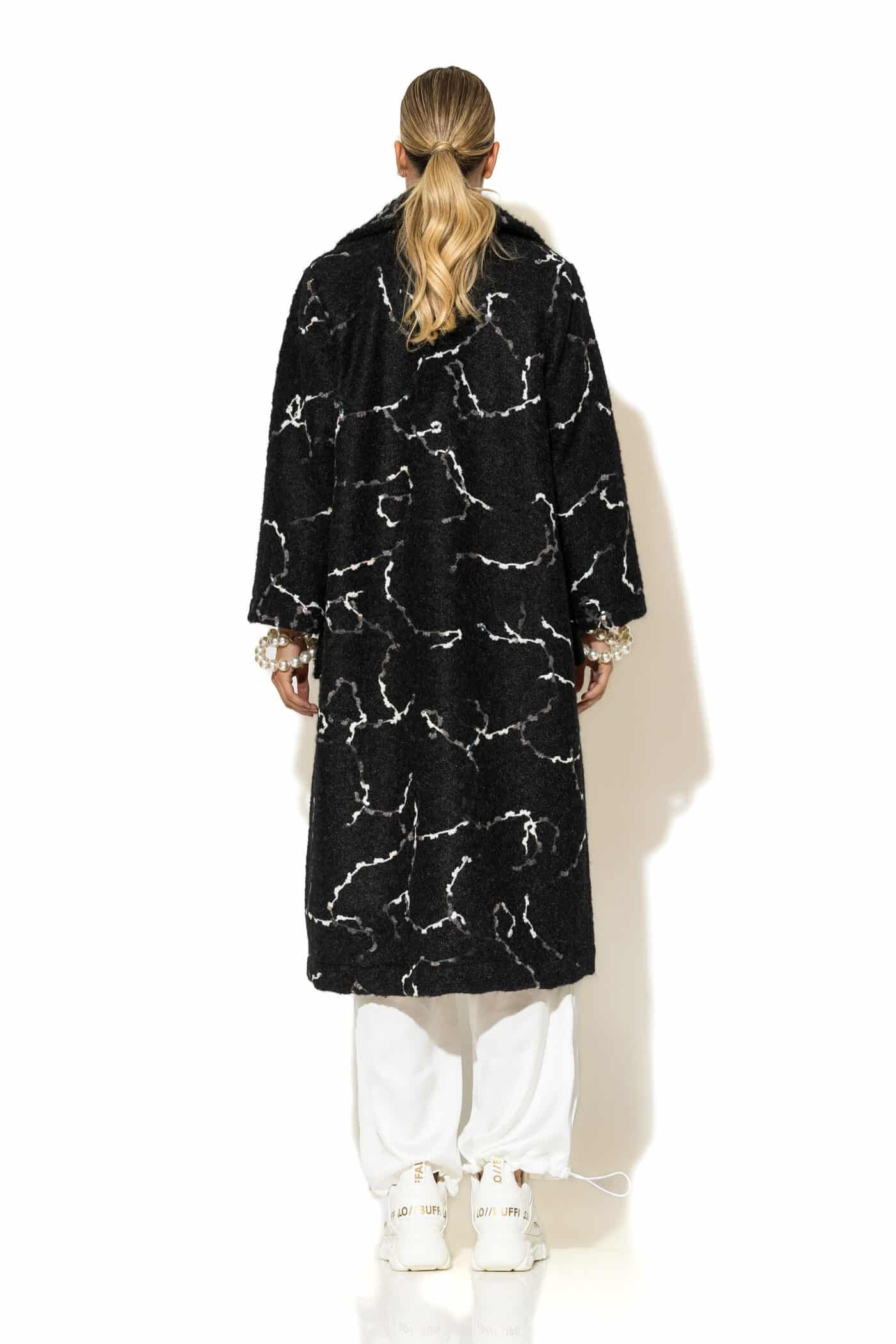 Back view of women's long ecru bouclé jacquard coat with lining and clean silhouette