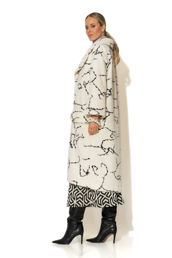 Side view of ecru bouclé coat with long sleeves and mid-calf length