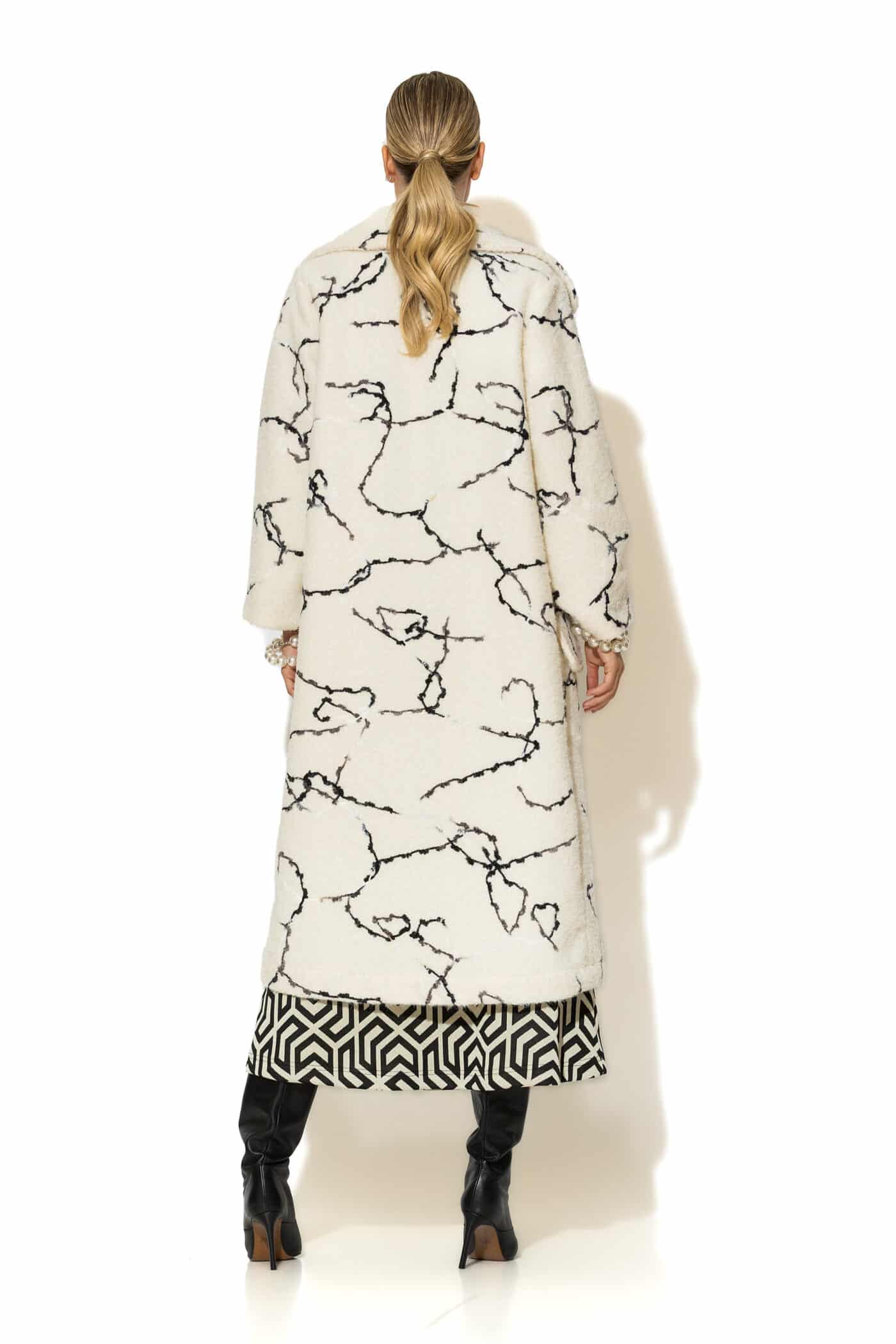 Back view of lined ecru bouclé coat with clean silhouette and soft texture