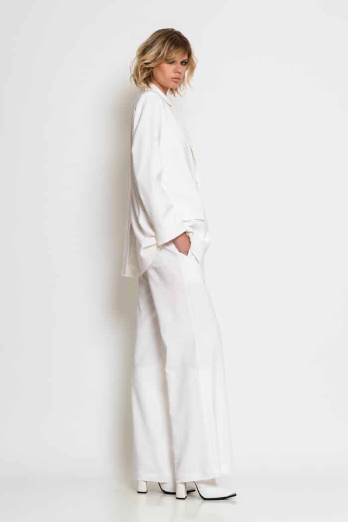 White wide-leg crepe trousers with front flap pockets, elasticated back waistband and back patch pockets.
